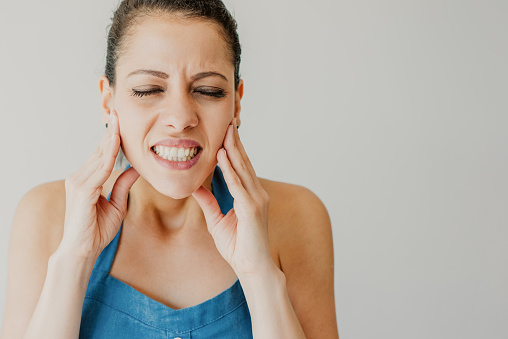 Woman dealing with bruxism and in pain.