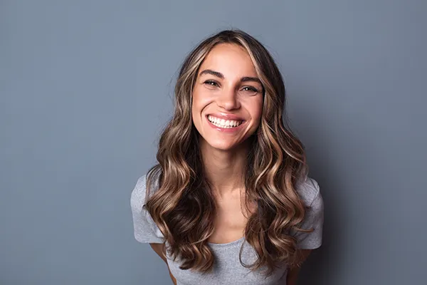 Joyful young white woman smiling and showing off her beautiful teeth at Lakewood Dental Arts in Lakewood, CA