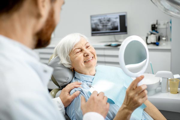 Elderly woman enjoying her new smile at Lakewood Dental Arts in Lakewood, CA. Elderly woman enjoying her new smile at Lakewood Dental Arts in Lakewood, CA.