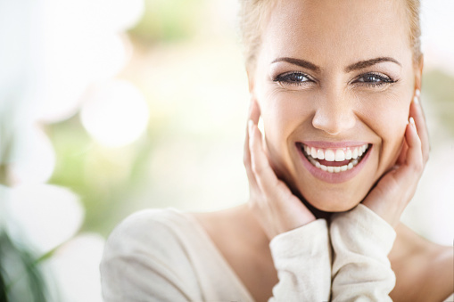 Woman with white teeth smiling after dental bonding procedure from Lakewood Dental Arts in Lakewood, CA